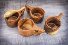 Laden des Bilds im Galerie-Viewer, Handcrafted Kuksa mugs made from acacia wood in Scandinavian design, five natural wooden cups with ergonomic handles, artfully arranged on a wooden table